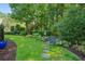 Beautiful garden path with stone steps surrounded by lush greenery and colorful flowers at 1382 Murrays Loch Nw Pl, Kennesaw, GA 30152