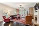 Comfortable living room with a fireplace, plush seating, and access to the sunroom at 1382 Murrays Loch Nw Pl, Kennesaw, GA 30152
