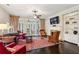 Cozy living room with a fireplace, built-in shelving, and an attached sunroom at 1382 Murrays Loch Nw Pl, Kennesaw, GA 30152