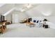 Spacious living room features a neutral-toned carpet, light walls, vaulted ceiling and two ceiling fans to enhance the home's appeal at 1382 Murrays Loch Nw Pl, Kennesaw, GA 30152