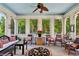 Relaxing porch features arched windows with views to the exterior of the property and charming decor at 1382 Murrays Loch Nw Pl, Kennesaw, GA 30152