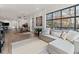 Bright living room with a large sectional sofa, natural light from expansive windows, and stylish decor at 1494 Red Fox Ne Dr # D, Atlanta, GA 30306