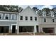 A row of gray townhouses featuring unfinished garages and lots of natural light at 158 Bluffington Way, Marietta, GA 30066