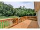 Spacious wooden back deck with railing overlooking a fenced yard with trees at 4237 Rickenbacker Ne Way, Atlanta, GA 30342
