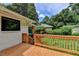 Back deck showcases stairs to the backyard and a view of the house and greenery at 4237 Rickenbacker Ne Way, Atlanta, GA 30342