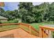 Inviting wood back deck overlooking a lush green lawn and mature trees for outdoor living at 4237 Rickenbacker Ne Way, Atlanta, GA 30342