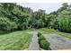 The backyard offers a mix of grass, a rock area, and lush trees for privacy at 4237 Rickenbacker Ne Way, Atlanta, GA 30342