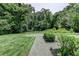 The backyard offers a mix of grass, a rock area, and lush trees for privacy at 4237 Rickenbacker Ne Way, Atlanta, GA 30342