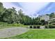 Landscaped backyard with trees, lawn, and gravel area, creating a private outdoor retreat at 4237 Rickenbacker Ne Way, Atlanta, GA 30342