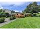 A charming home with a wooden deck and a lush lawn, with a modern building adjacent at 4237 Rickenbacker Ne Way, Atlanta, GA 30342