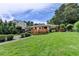 The backyard presents a wooden deck, lush lawn, and privacy from mature trees at 4237 Rickenbacker Ne Way, Atlanta, GA 30342