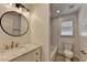 Bathroom featuring modern vanity with marble counter, round mirror, and soaking tub at 4237 Rickenbacker Ne Way, Atlanta, GA 30342