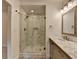 Bathroom with a modern shower with marble tile and a granite topped vanity at 4237 Rickenbacker Ne Way, Atlanta, GA 30342