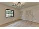 Bright bedroom with hardwood floors, a stylish light fixture, and double closets at 4237 Rickenbacker Ne Way, Atlanta, GA 30342