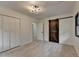 Light-filled bedroom with closet and barn door, complemented by stylish light fixture at 4237 Rickenbacker Ne Way, Atlanta, GA 30342