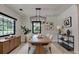 Elegant dining room with modern light fixture and large windows at 4237 Rickenbacker Ne Way, Atlanta, GA 30342