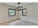 Bright dining room with modern chandelier and large windows at 4237 Rickenbacker Ne Way, Atlanta, GA 30342