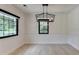 Spacious dining room with modern light fixture and large windows at 4237 Rickenbacker Ne Way, Atlanta, GA 30342