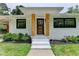 Inviting entrance featuring a rustic wood door, stylish pillars, and manicured front lawn at 4237 Rickenbacker Ne Way, Atlanta, GA 30342