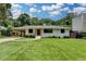 Charming one-story brick home with a well-manicured lawn and a convenient covered carport at 4237 Rickenbacker Ne Way, Atlanta, GA 30342