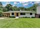 Charming single-story home with a carport and beautifully maintained front lawn at 4237 Rickenbacker Ne Way, Atlanta, GA 30342
