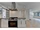 Open kitchen with stainless steel appliances, range hood, and a view of the adjacent living space at 4237 Rickenbacker Ne Way, Atlanta, GA 30342