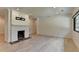 Spacious living room featuring a white brick fireplace, hardwood floors, and neutral walls at 4237 Rickenbacker Ne Way, Atlanta, GA 30342