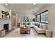 Cozy living room with white fireplace, a large window and comfortable furniture at 4237 Rickenbacker Ne Way, Atlanta, GA 30342