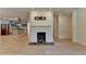 Spacious living room with white brick fireplace and light hardwood floors at 4237 Rickenbacker Ne Way, Atlanta, GA 30342