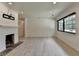 Bright and open living room with a white brick fireplace, light wood floors, and contemporary lighting at 4237 Rickenbacker Ne Way, Atlanta, GA 30342