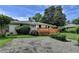 Charming single-story home featuring a spacious deck, landscaped yard, and gravel driveway at 4237 Rickenbacker Ne Way, Atlanta, GA 30342