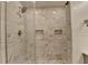 Elegant shower features marble tile surround, rainfall shower head, and built-in niches at 4237 Rickenbacker Ne Way, Atlanta, GA 30342