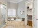Luxurious primary bathroom with a soaking tub, separate shower, and access to a walk-in closet at 125 Franklin Pl, Atlanta, GA 30342