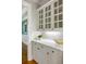 Convenient butler's pantry with custom cabinetry, granite countertops, and a view into the dining room at 125 Franklin Pl, Atlanta, GA 30342