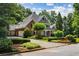 Stunning two-story home with a well-maintained lawn, mature trees, and a long driveway leading to the garage at 125 Franklin Pl, Atlanta, GA 30342