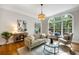 Bright living room with hardwood floors, large arched windows, and a comfortable seating area at 125 Franklin Pl, Atlanta, GA 30342