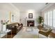 Elegant living room with a marble fireplace, neutral walls, hardwood floors, and a leather sofa at 125 Franklin Pl, Atlanta, GA 30342