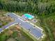 An aerial view of a community pool with parking, a playground, and landscaping at 1570 Ribbon Mill Sw Ln, Mableton, GA 30126