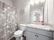 Bathroom with single sink vanity, and shower/tub combo with floral shower curtain at 1570 Ribbon Mill Sw Ln, Mableton, GA 30126