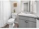 Neat bathroom with a toilet, sink and vanity with light grey cabinet at 1570 Ribbon Mill Sw Ln, Mableton, GA 30126