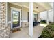 Inviting front porch with seating, a stylish welcome mat, and manicured landscaping at 1570 Ribbon Mill Sw Ln, Mableton, GA 30126