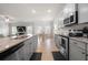 Bright, open-concept kitchen with stainless steel appliances and a view of the living area at 1570 Ribbon Mill Sw Ln, Mableton, GA 30126