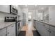 Modern kitchen featuring stainless steel appliances, granite countertops, and ample cabinet space at 1570 Ribbon Mill Sw Ln, Mableton, GA 30126