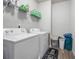 Functional laundry room featuring modern washer and dryer units, shelving, and storage at 1570 Ribbon Mill Sw Ln, Mableton, GA 30126