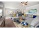 Spacious living room with a ceiling fan, comfortable seating, and a view of the kitchen at 1570 Ribbon Mill Sw Ln, Mableton, GA 30126