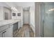 Bright main bathroom with double vanity, granite countertops, and a glass enclosed shower at 1570 Ribbon Mill Sw Ln, Mableton, GA 30126