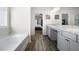 Bright main bathroom with double vanity, granite countertops, and a soaking tub at 1570 Ribbon Mill Sw Ln, Mableton, GA 30126