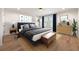 Stylishly staged bedroom with a blue upholstered bed frame, hardwood floors, and coordinated decor at 650 Moores Mill Nw Rd # 1, Atlanta, GA 30327