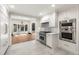 Bright kitchen features stainless steel appliances and a large passthrough to a sunlit seating area at 650 Moores Mill Nw Rd # 1, Atlanta, GA 30327