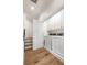 A well-lit laundry room with hardwood flooring, white cabinets, and modern washer and dryer at 650 Moores Mill Nw Rd # 1, Atlanta, GA 30327